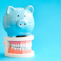 light blue piggy bank sitting on dentures