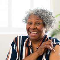 Woman happy about dentures in Astoria 