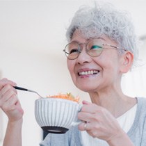 Woman with dentures in Astoria 