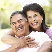 Smiling older couple with dentures in Astoria