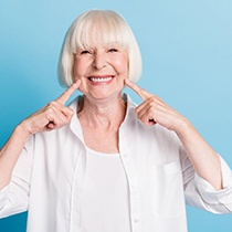 Senior woman pointing to her smile