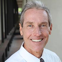 Older man with tie and dentures