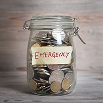 Jar with change inside it labeled 'emergency'