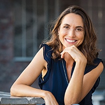 Woman smiling after visiting emergency dentist in Astoria