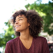 person smiling while walking around a town