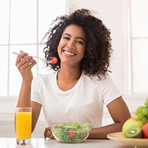 young woman eating a salad 