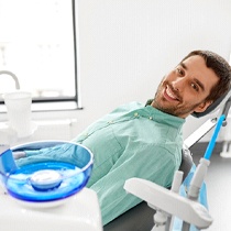 Man with dental implants in Astoria visiting the dentist