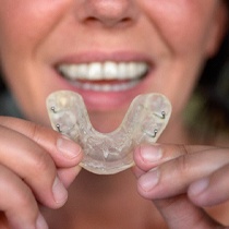 Woman holding a custom-made mouthguard