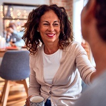 smiling woman talking to her dentist