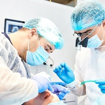 dentists performing dental implant surgery