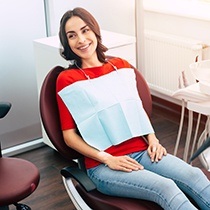 smiling woman waiting for her dentist in the treatment chair