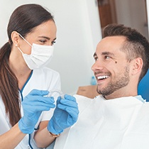 Patient and dentist smiling while discussing Invisalign