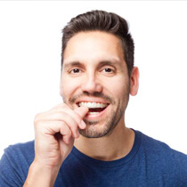 Man placing an Invisalign tray