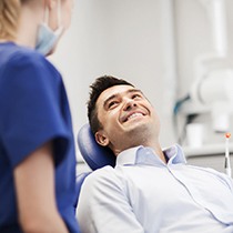 Happy patient looking at dental team member