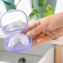 Person holding a nightguard while it’s in its case