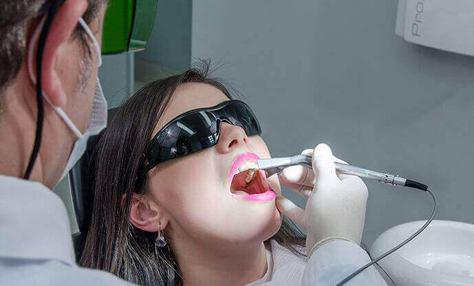 Patient with shades getting teeth examined
