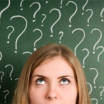 Woman surrounded by question marks