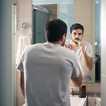 man brushing teeth