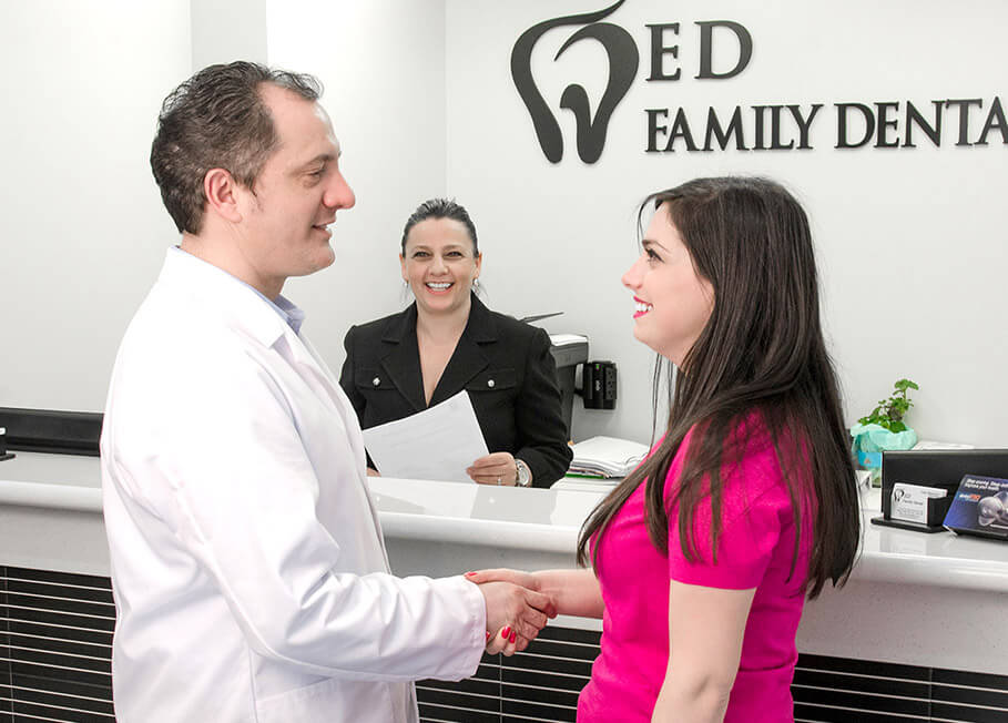 Doctor Shkurti shaking hands with patient in Astoria