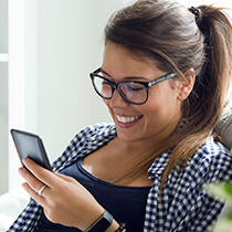 Lady with glasses using her phone