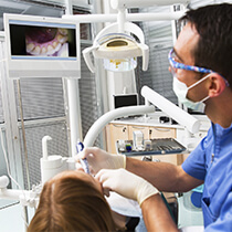 dentist viewing patient’s teeth using intraoral camera