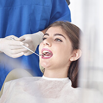 Lady being examined by dentist