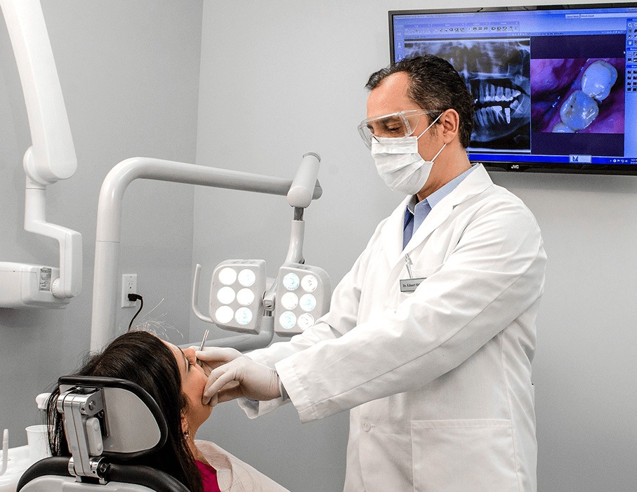 Doctor Shkurti examining Astoria dental patient