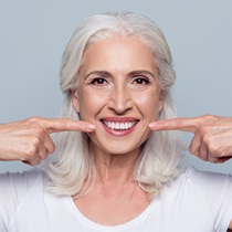 woman pointing to her teeth