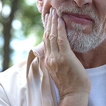 a man holding his jaw 
