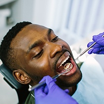 a man having his mouth examined by a dentist