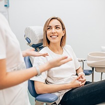 patient learning about the cost of veneers in Astoria from her dentist 