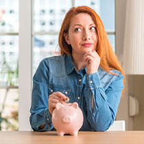 Woman saving money for teeth whitening in Astoria