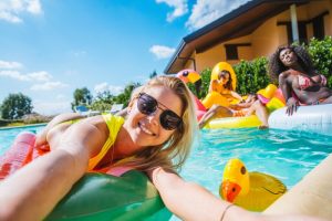 person taking a pool selfie with friends