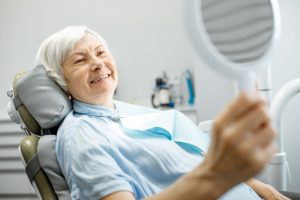 Patient smiling with dental implants in Astoria 