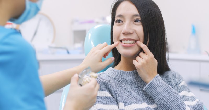 A woman receiving dental implants in Astoria