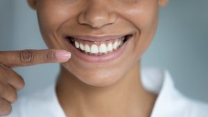 a social media influencer showing off their new smile with veneers