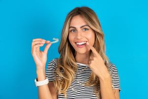 Young woman with her Invisalign aligner