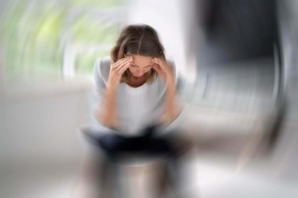 A woman experiencing dizziness